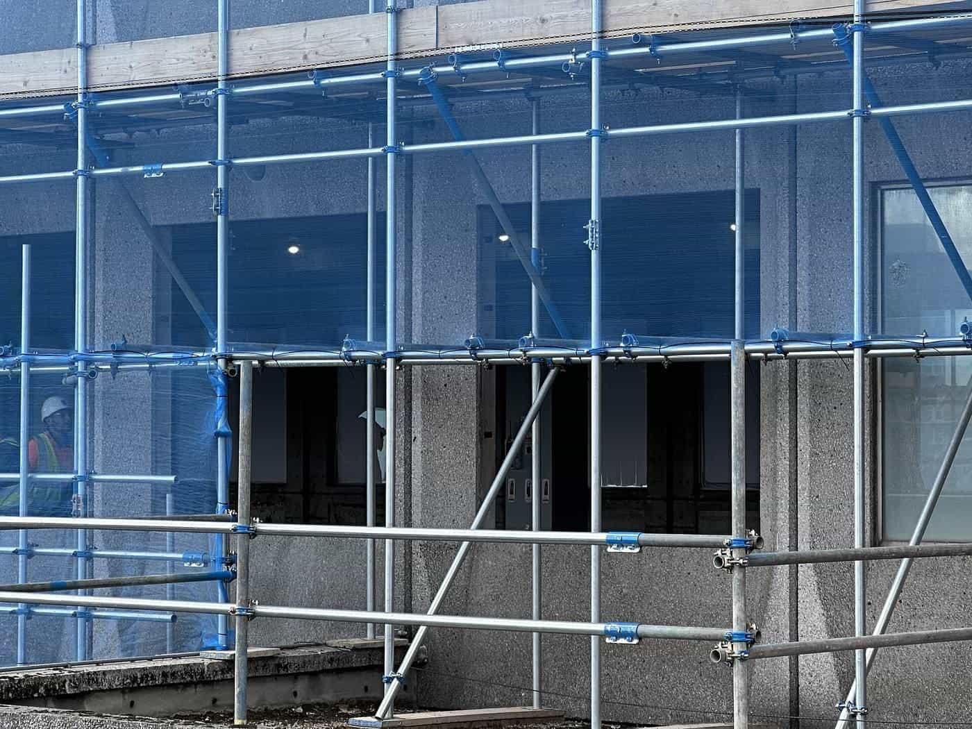 Metal scaffolding in front of a building under renovation