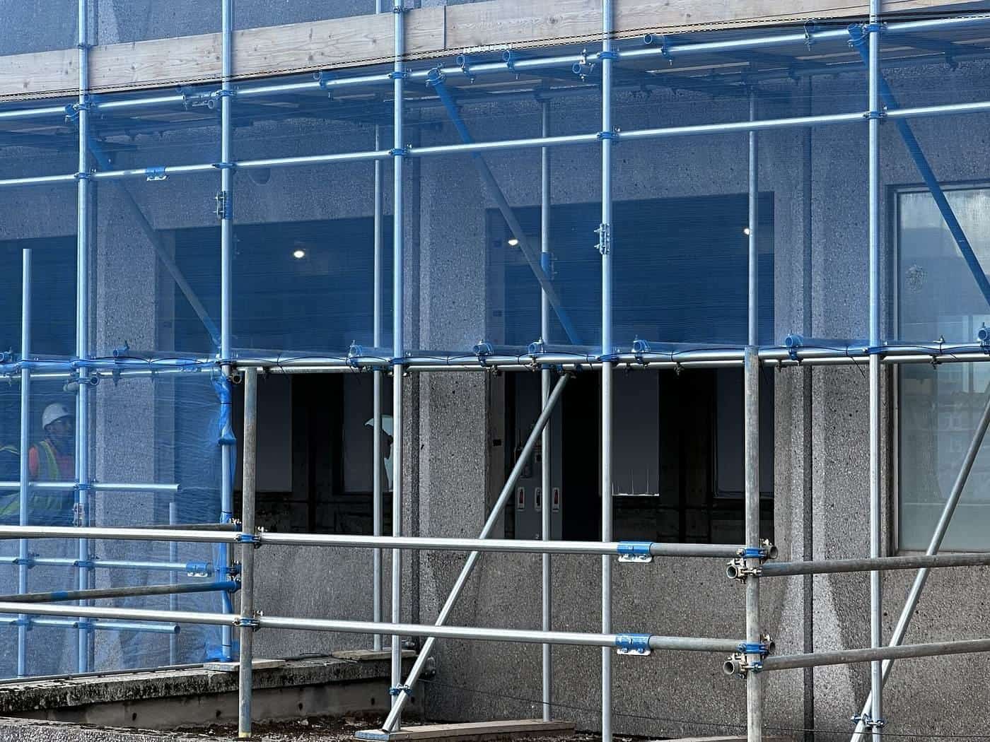 Metal scaffolding in front of a building under renovation